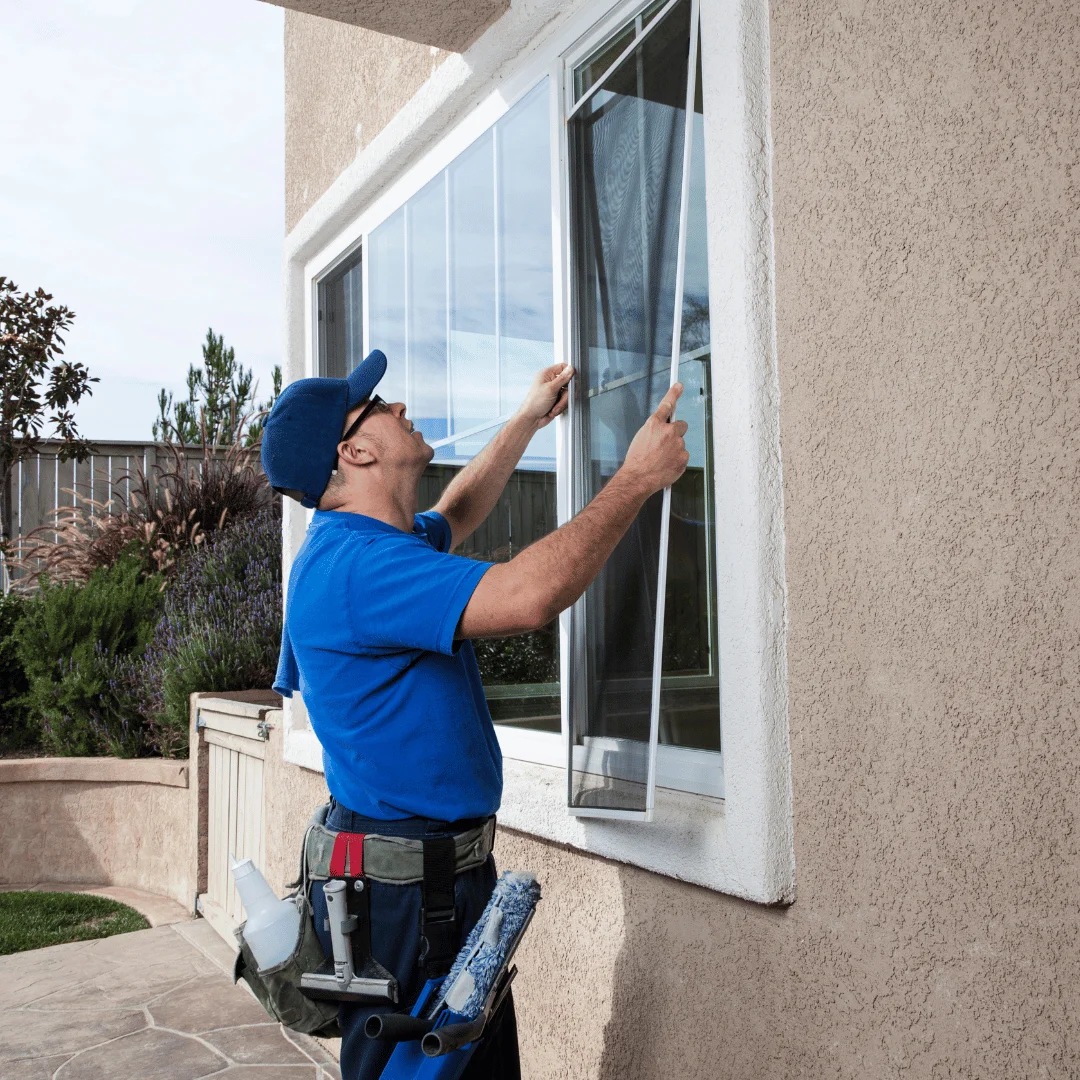 a man repairing a window screen