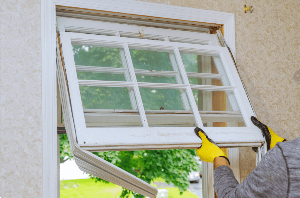 a window repair man replaces a home's windows.