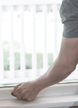 man trying to open window